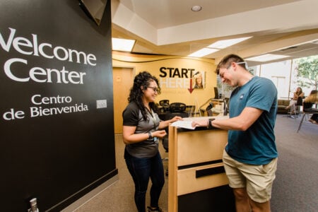 Staff member and student at Welcome Center