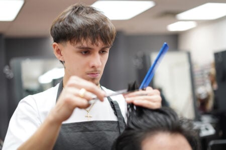 Cosmetology student cutting hair