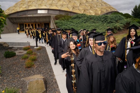 Many WWCC students walking out of the Dome towards the graduation ceremony.
