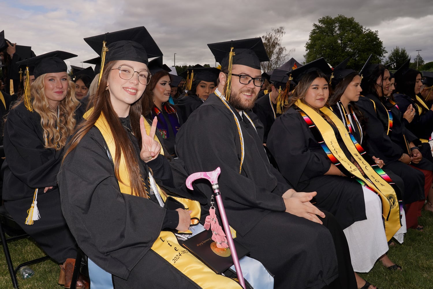Graduates smiling during graduation.