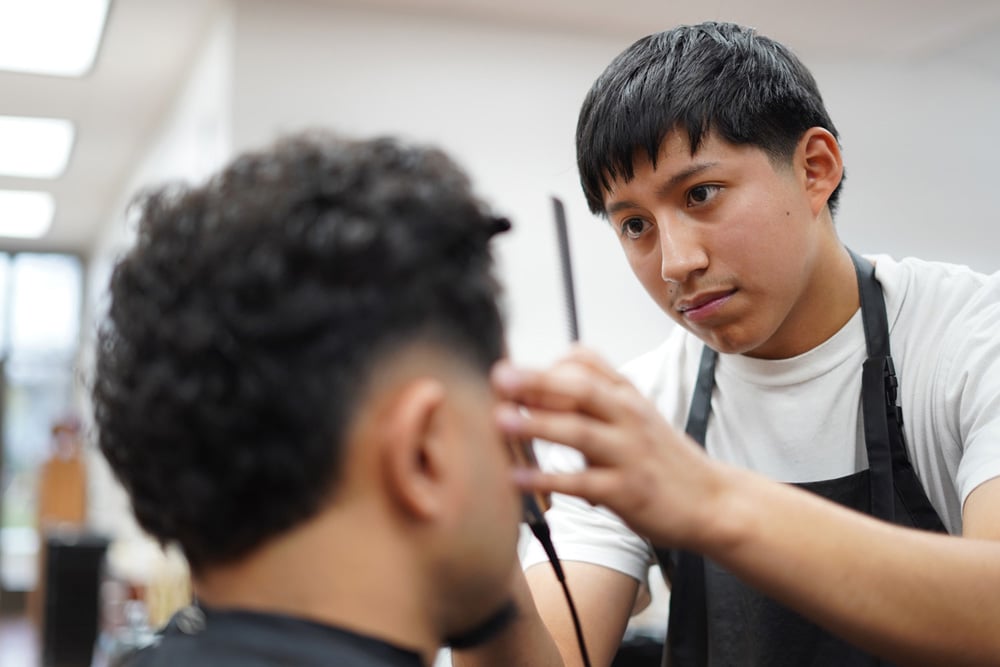 Barber student cutting hair