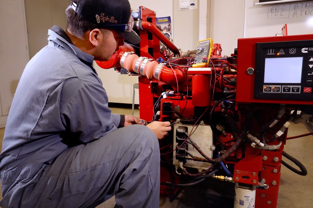Student working on diesel engine.