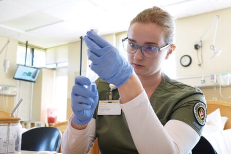 Nursing student with syringe