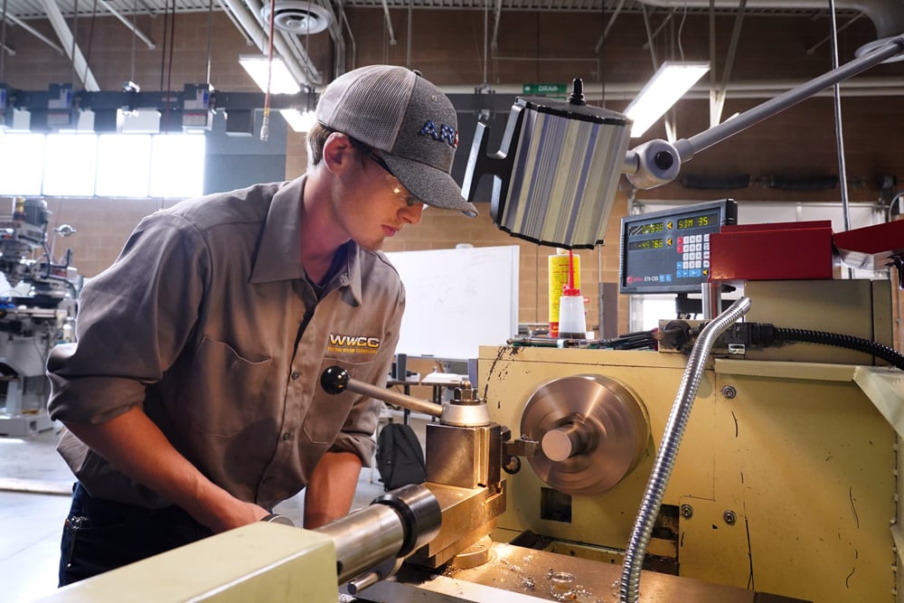 Student working using heavy machinery
