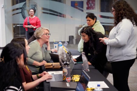 Staff assist students at an information table during a Walla Walla Community College campus event.
