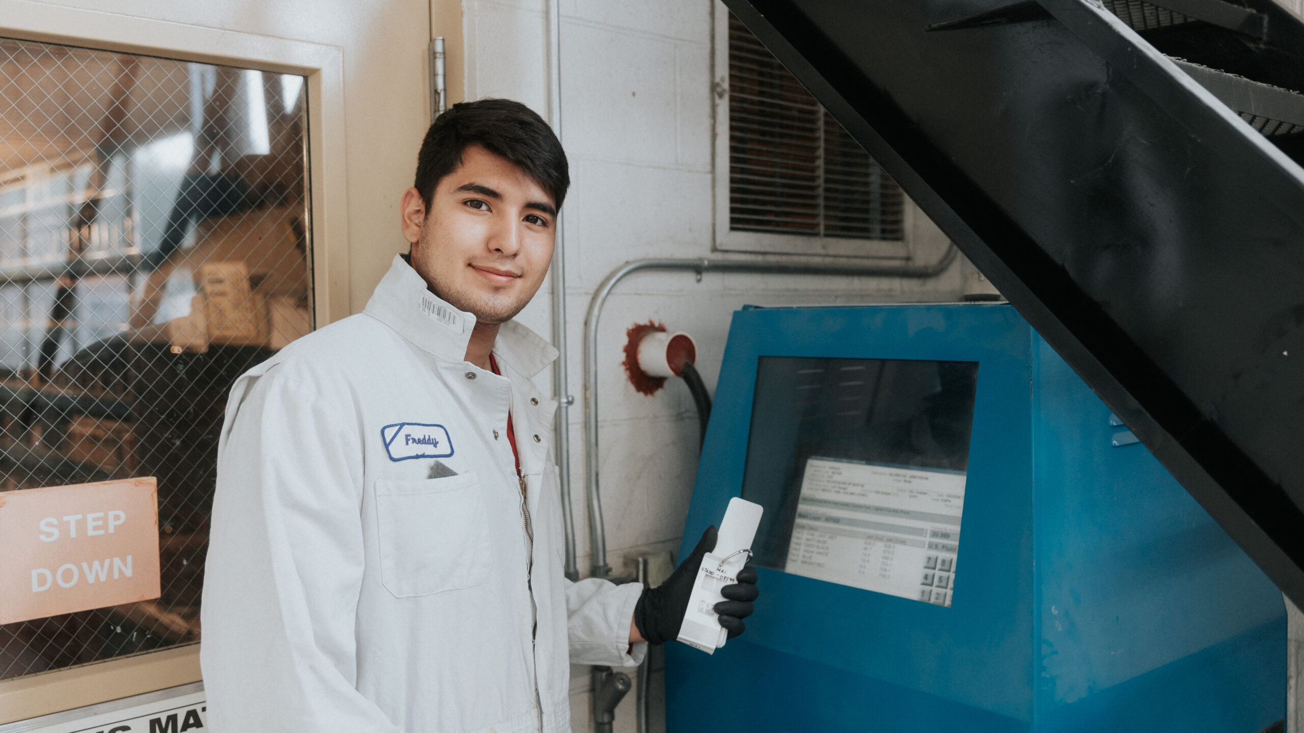 Workforce program student in front of machine
