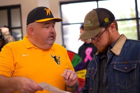 Staff assist students at an information table during a Walla Walla Community College campus event.