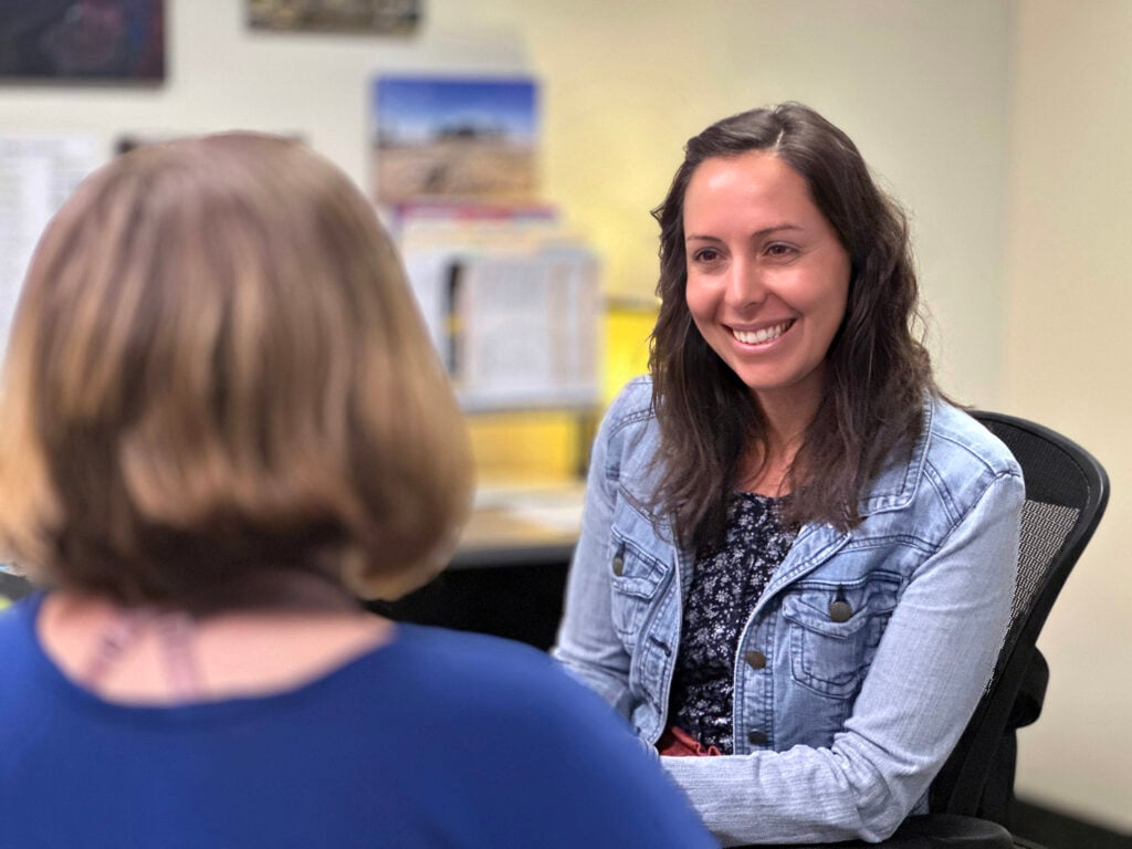 Navigator speaking to a student.