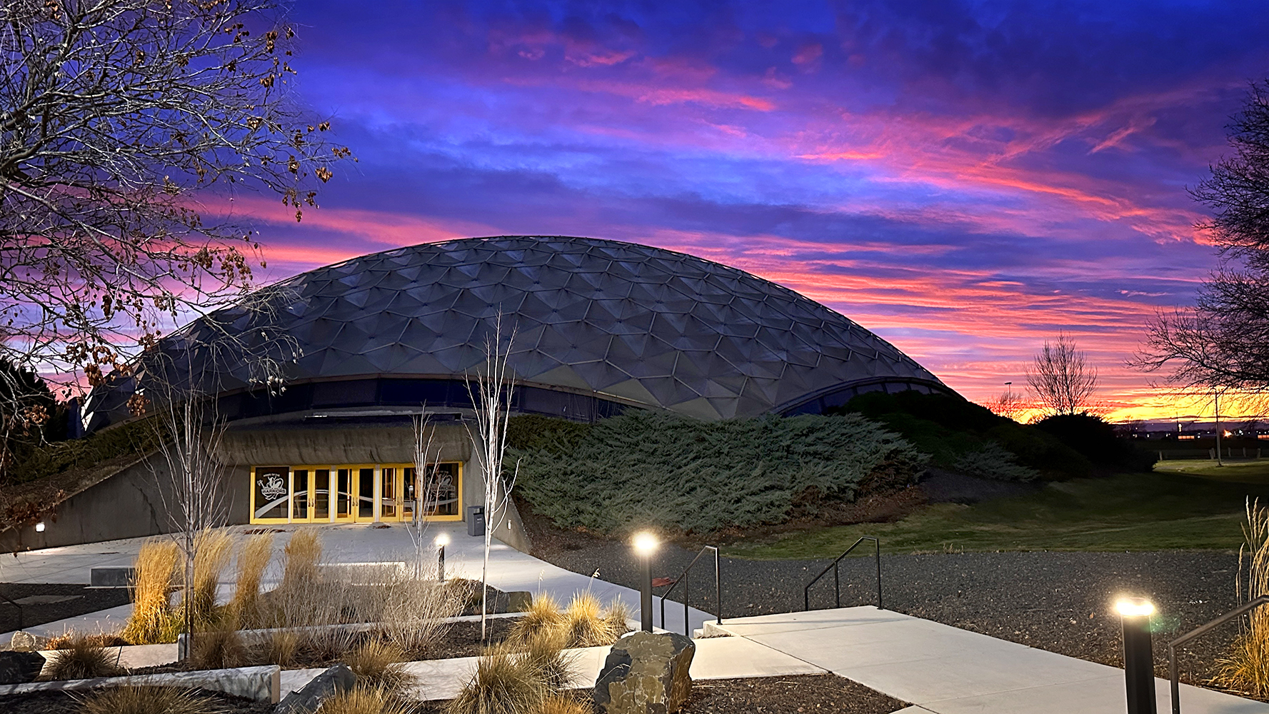image of the dome in front of a purple/pink sky.