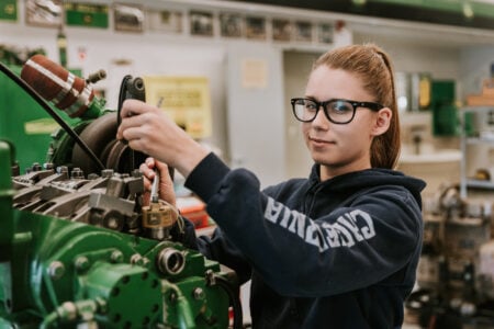 female student working on engine