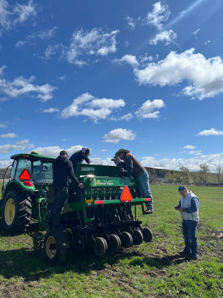 The group inspects equipment used by students in the John Deere Tech Center program.